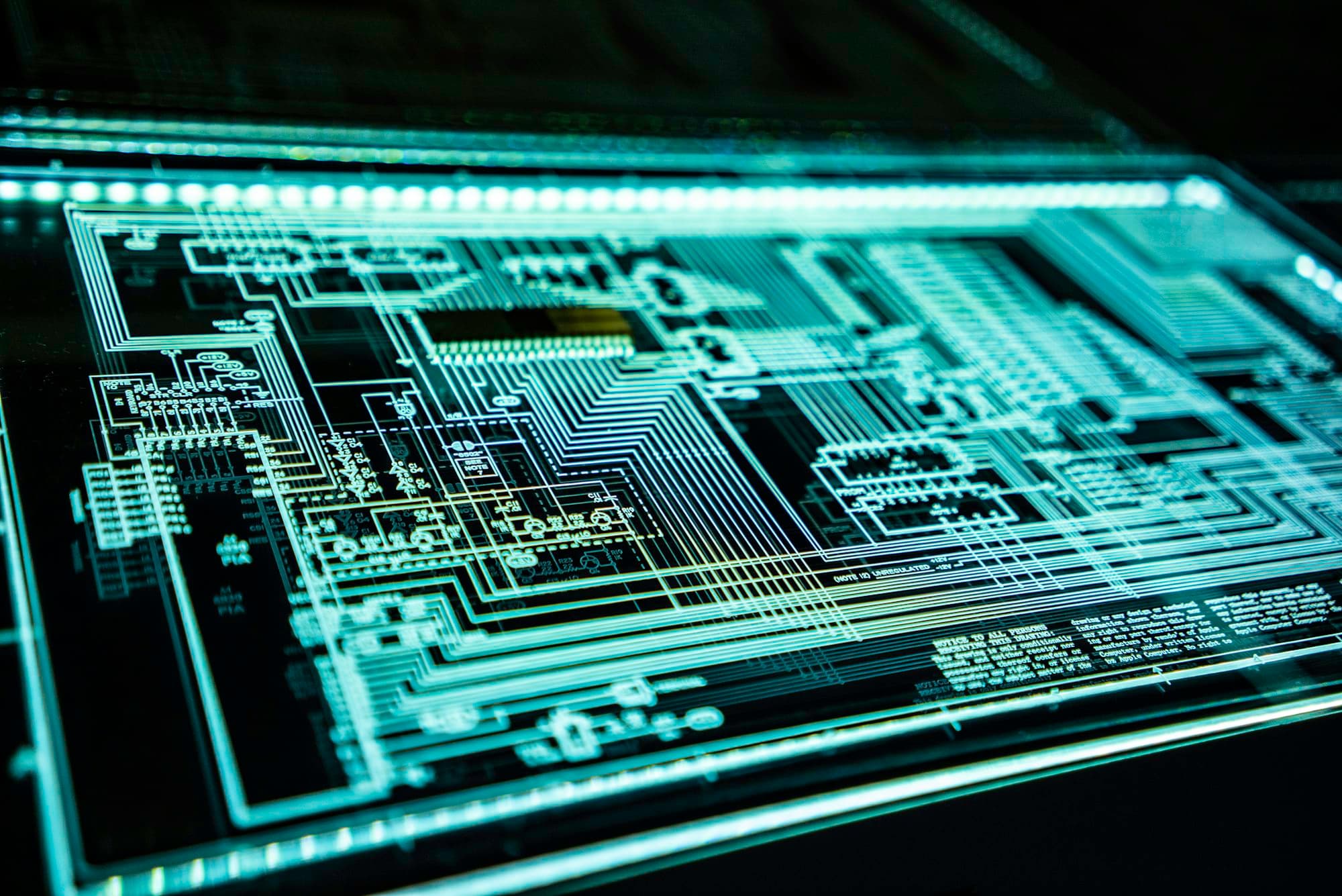Circuit board traces lit in teal